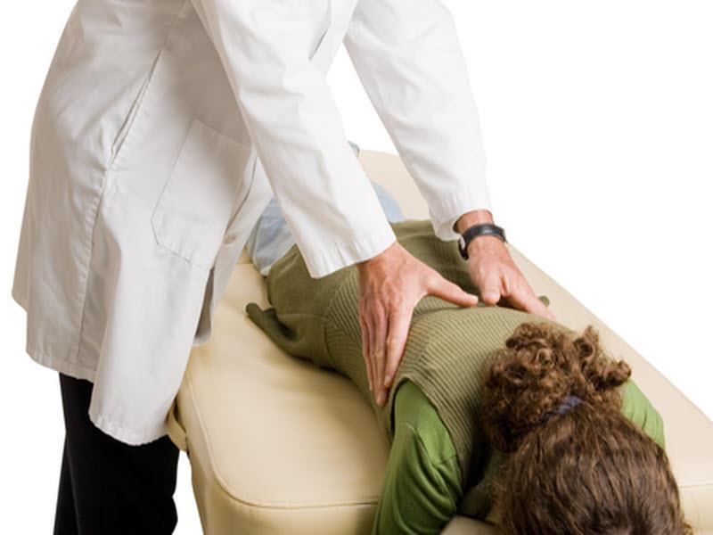 Practitioner performing a hands-on spinal treatment